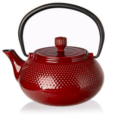 A red cast iron teapot with a textured dimple pattern, a black metal handle, and a matching red lid, shown on a white background with a subtle reflection.