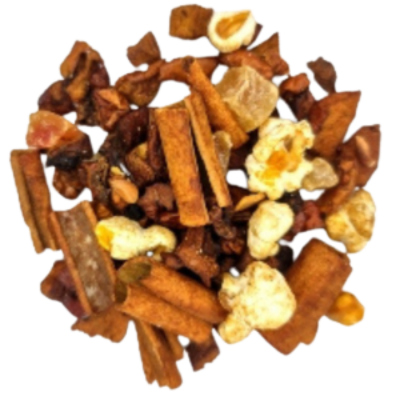 Assorted dried fruits and spices including cinnamon sticks and popcorn on a white background
