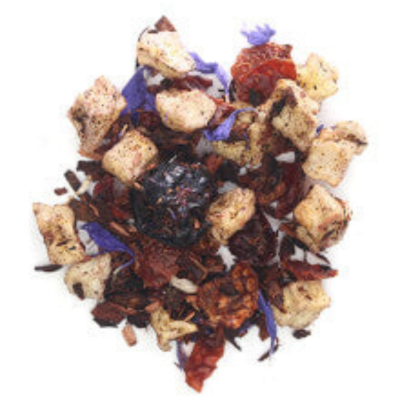 Assorted honeybush herbal tea leaves including dried blueberries, with maple, and herbs on a white background