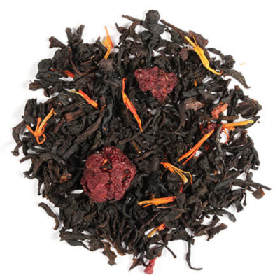 A close-up of loose black tea leaves with pieces of dried fruit and orange peel, indicating a flavored tea with berry and citrus elements.